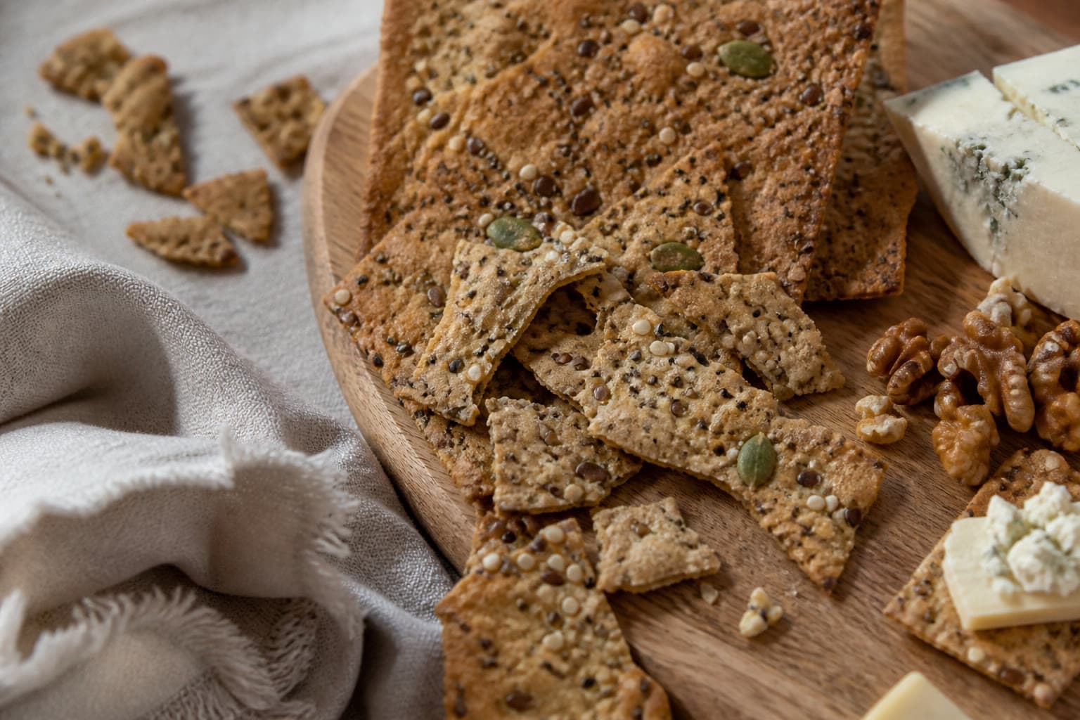 Seeded gluten-free sourdough discard crackers on linen